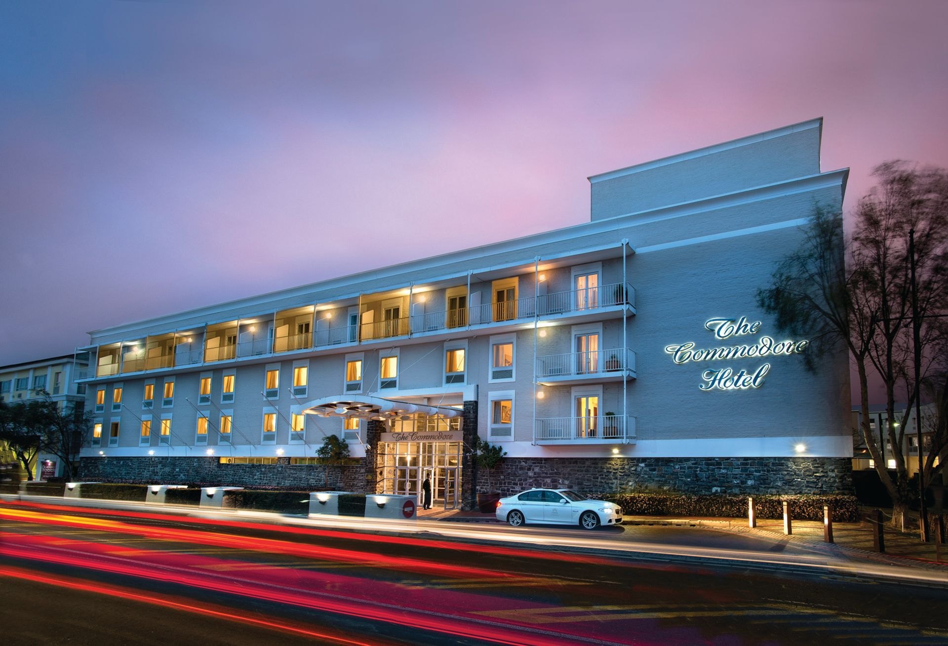 The illuminated entrance and exterior of The Commodore Hotel